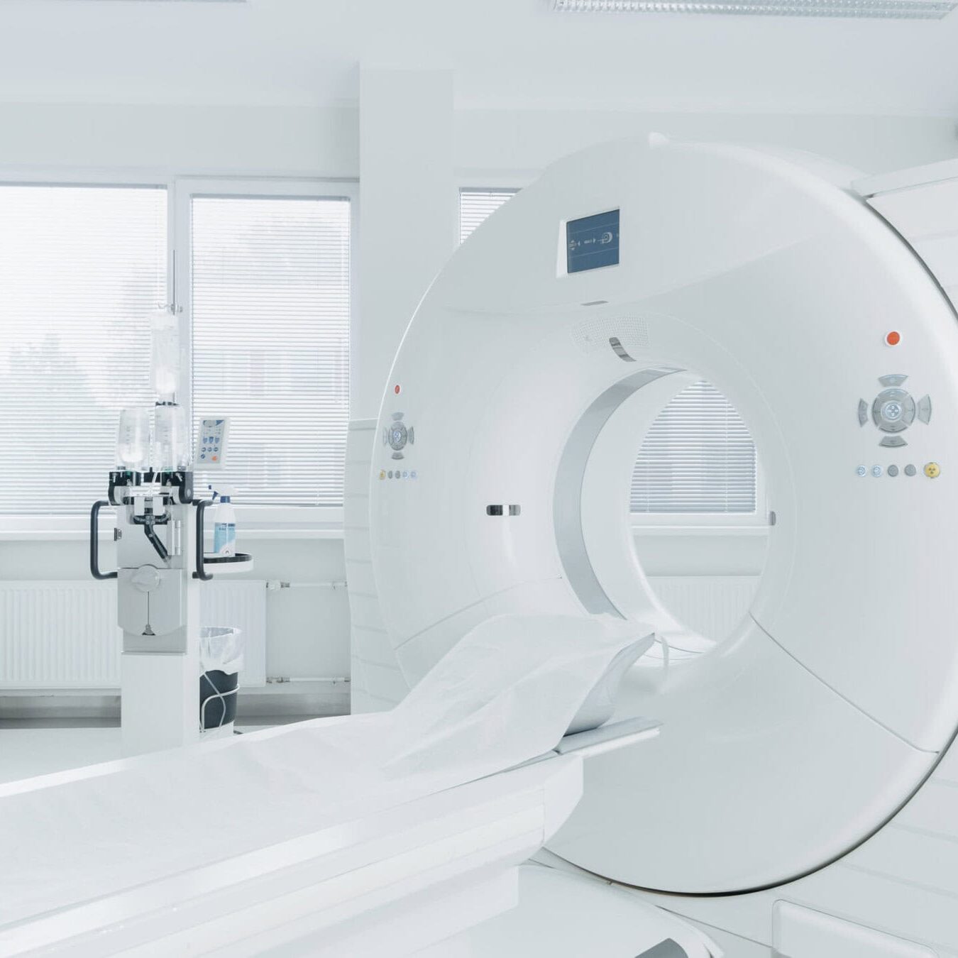 Medical CT or MRI or PET Scan Standing in the Modern Hospital Laboratory. Technologically Advanced and Functional Mediсal Equipment in a Clean White Room. Medical CT or MRI or PET Scan Standing in the Modern Hospital Laboratory. Technologically Advanced and Functional Mediсal Equipment in a Clean White Room.
