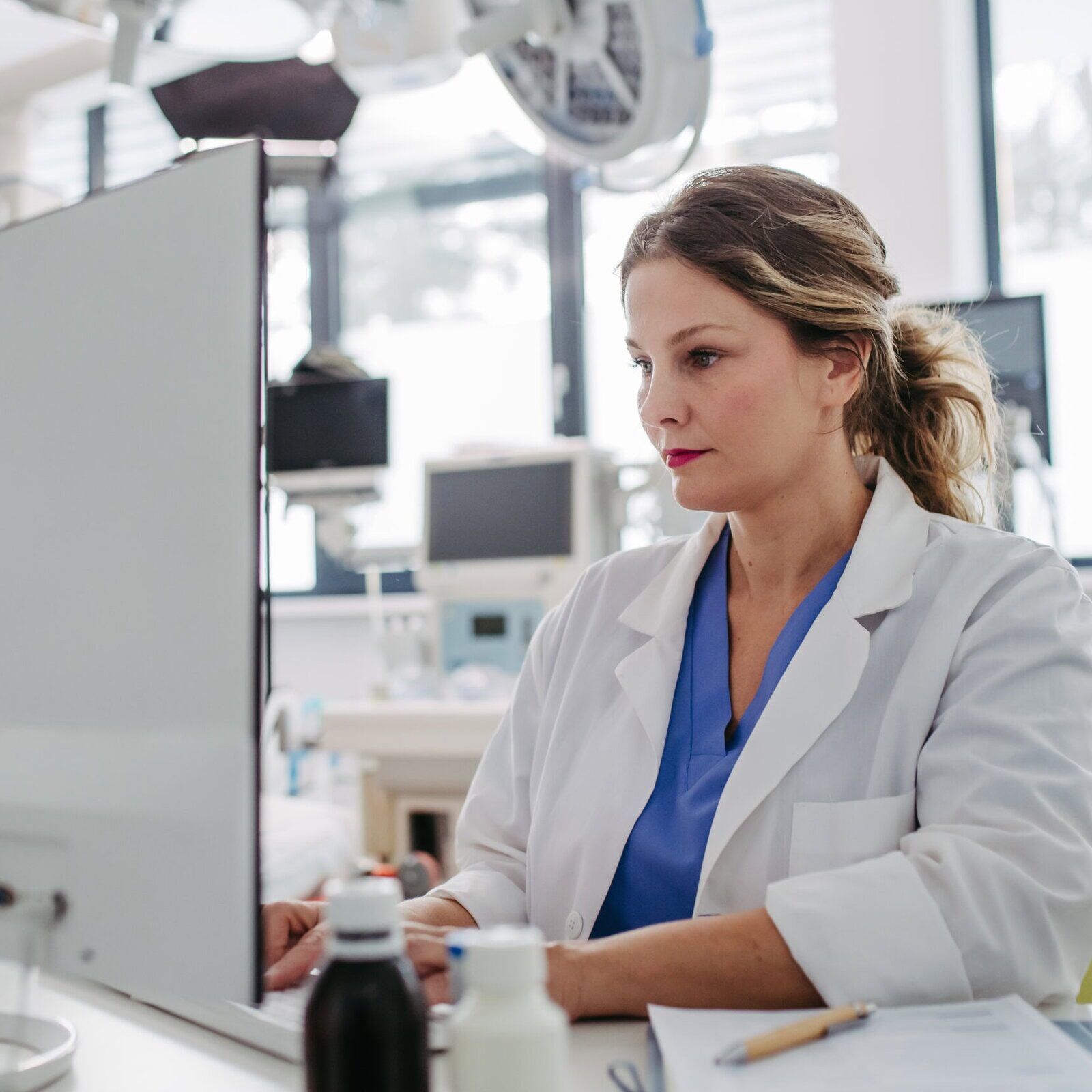 Female doctor working on computer in doctor's office.