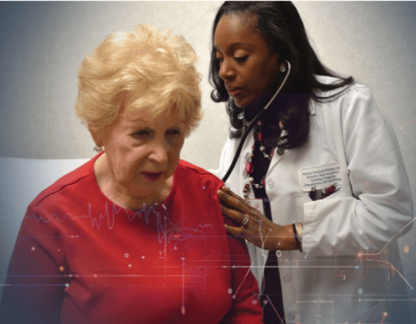 ASNC Education Committee Chair Renée Bullock-Palmer, MD, FASNC, examines a female patient. 